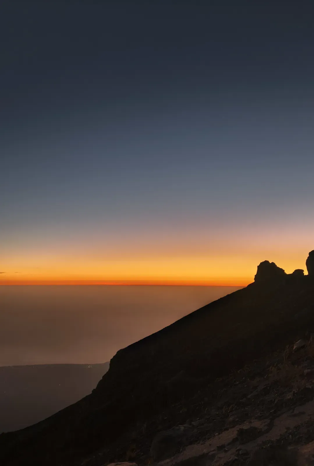 Orange sunrise sky along a Mount Agung mountain trail