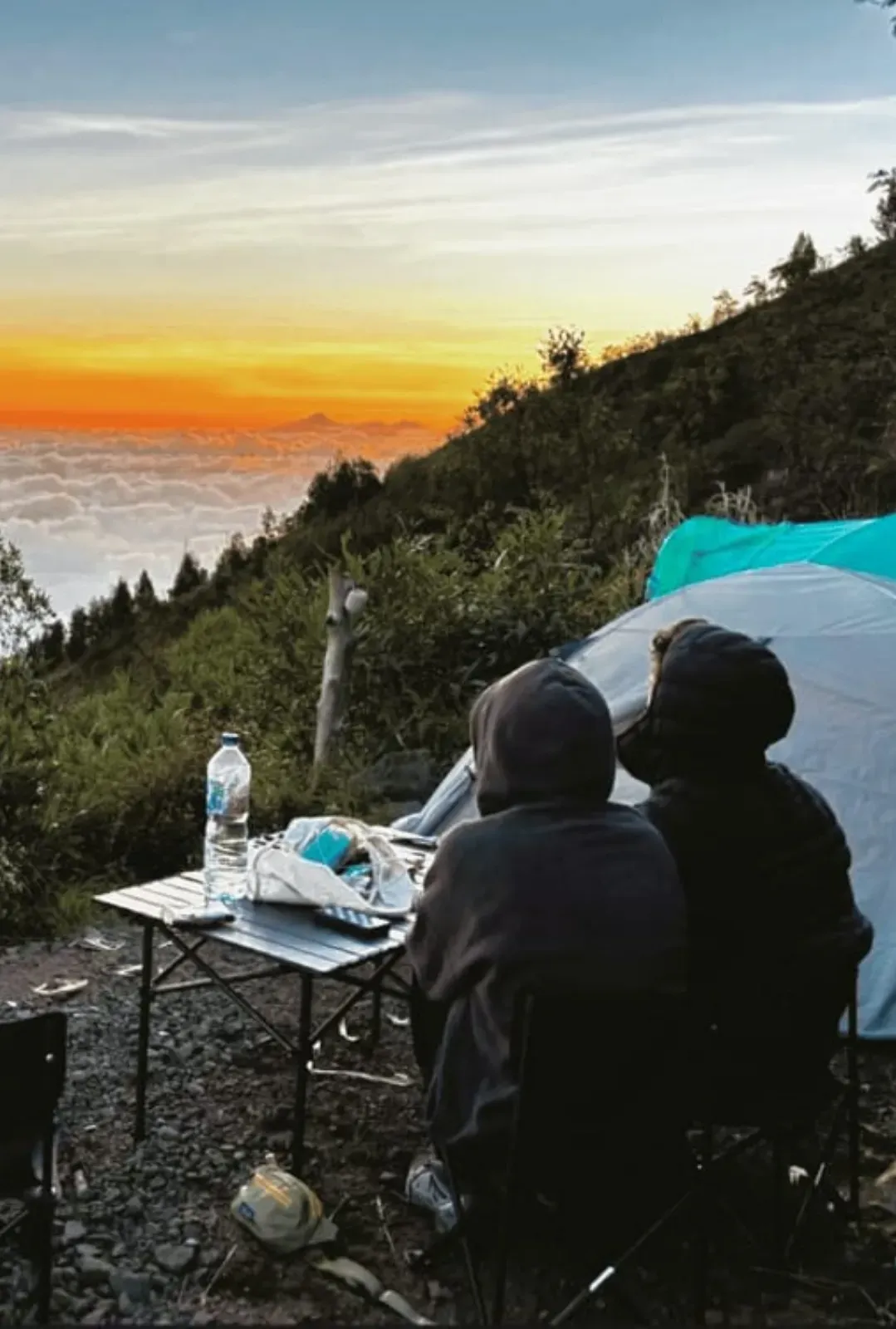 Campers watching sunrise from a Mount Agung campsite