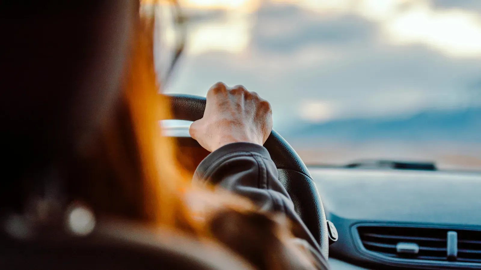 Driver at the wheel at sunset