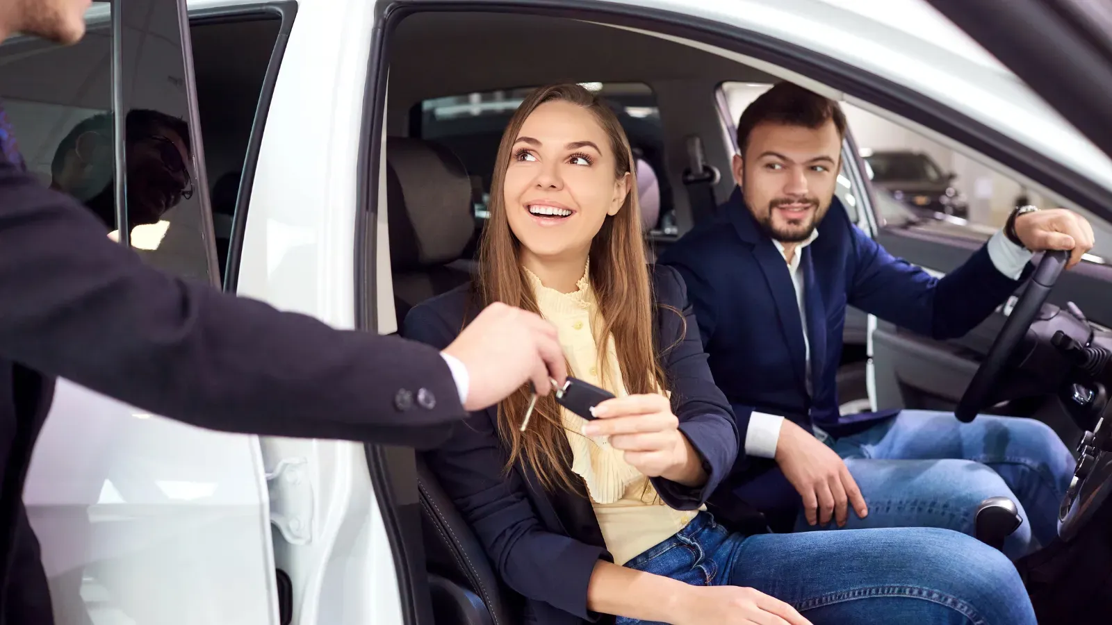 Guests receiving car keys inside a vehicle