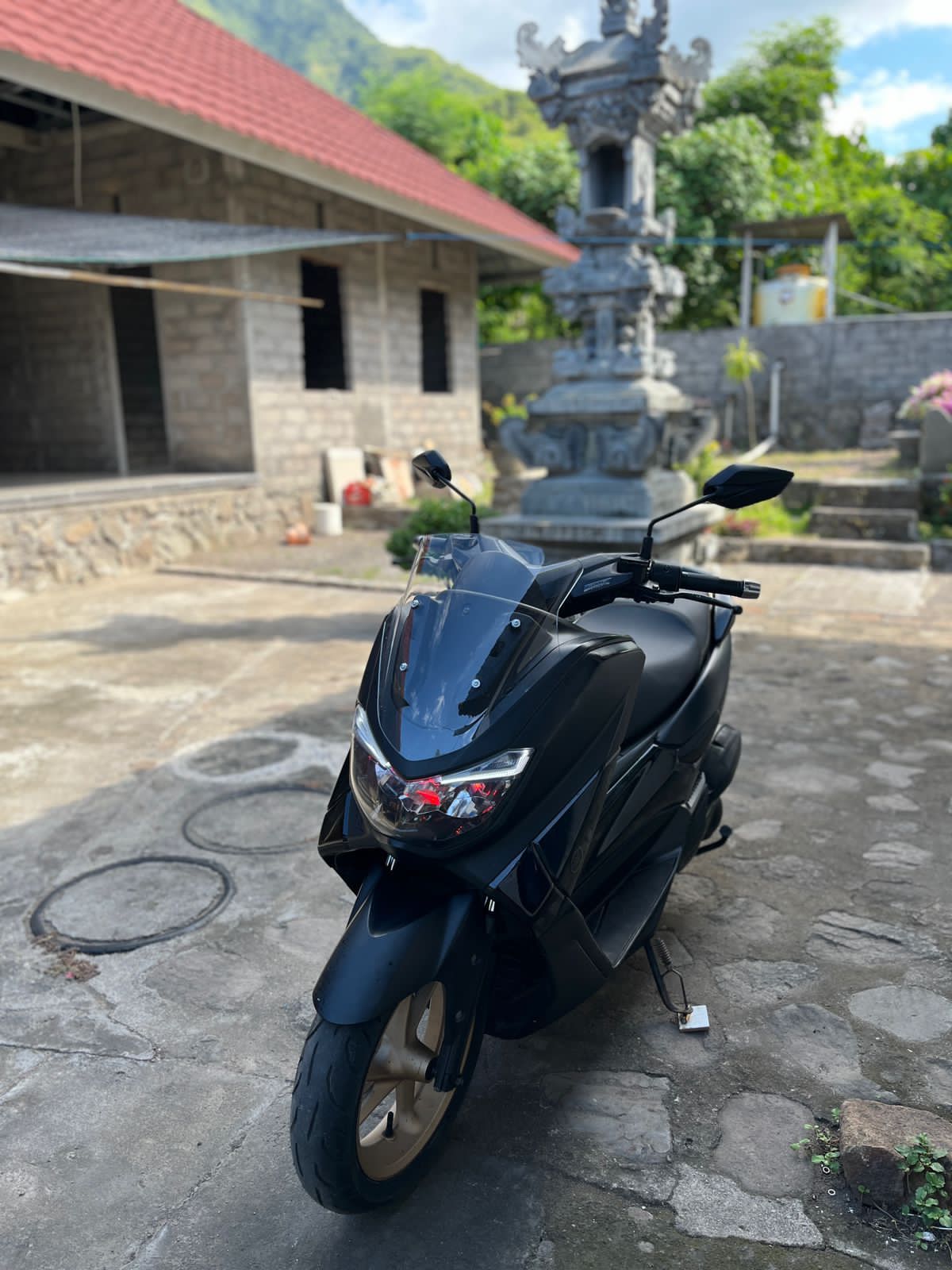 Scooter rental parked on a tropical road around Amed