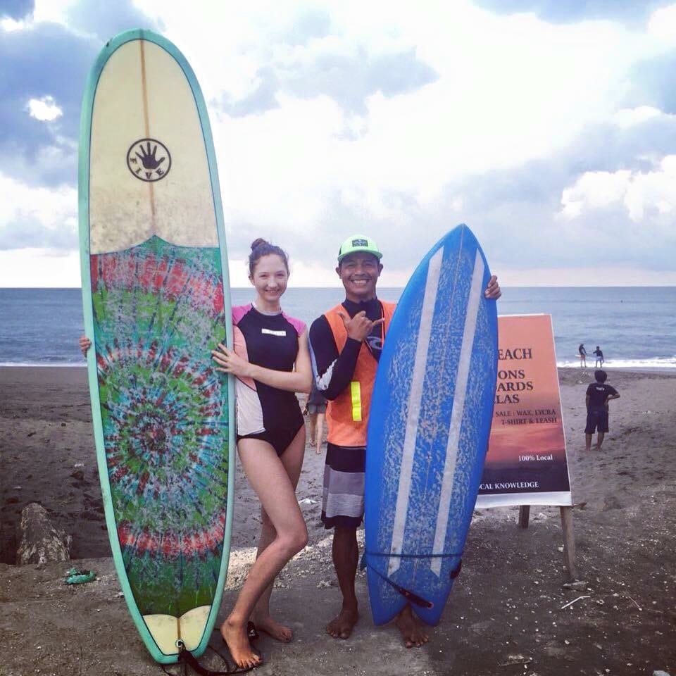 Surf coach helping a student in the water at Canggu