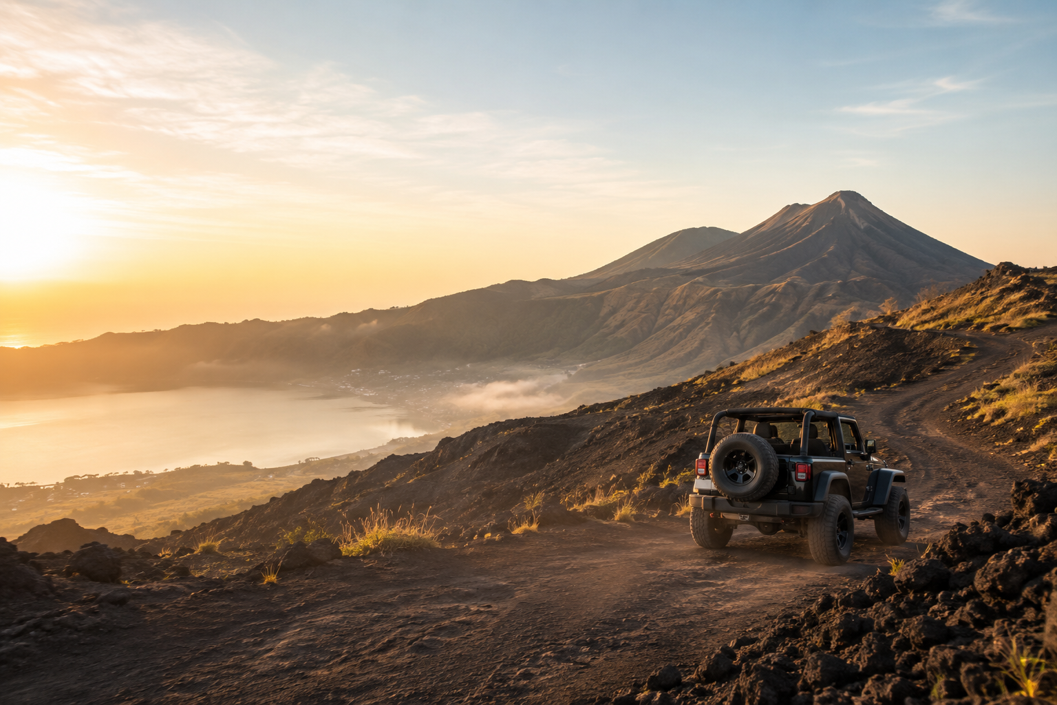 Sunrise breaking over volcanic mountain ridges above a sea of clouds in Bali