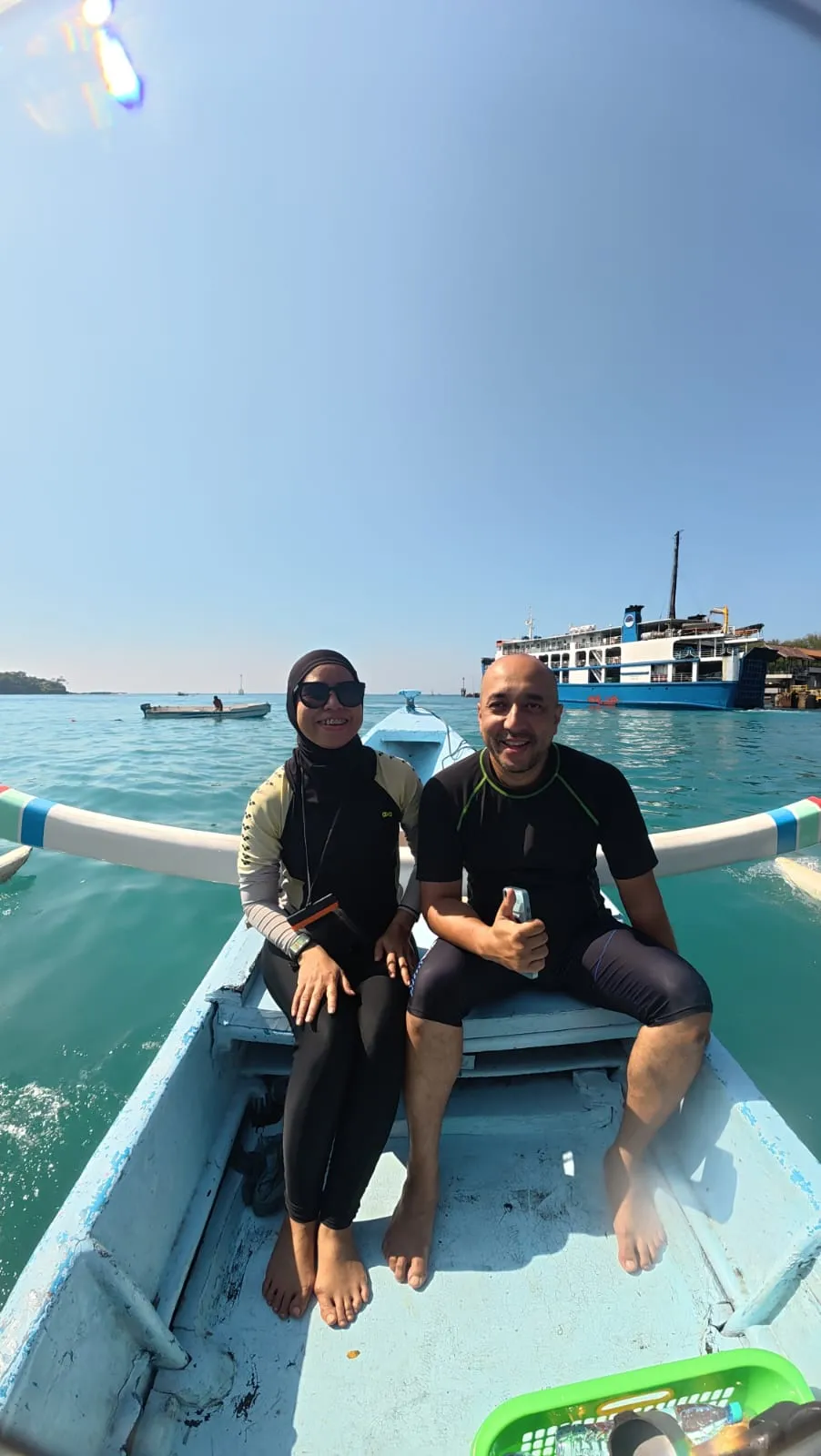 Fishing boat on open water with fishing equipment and coastline