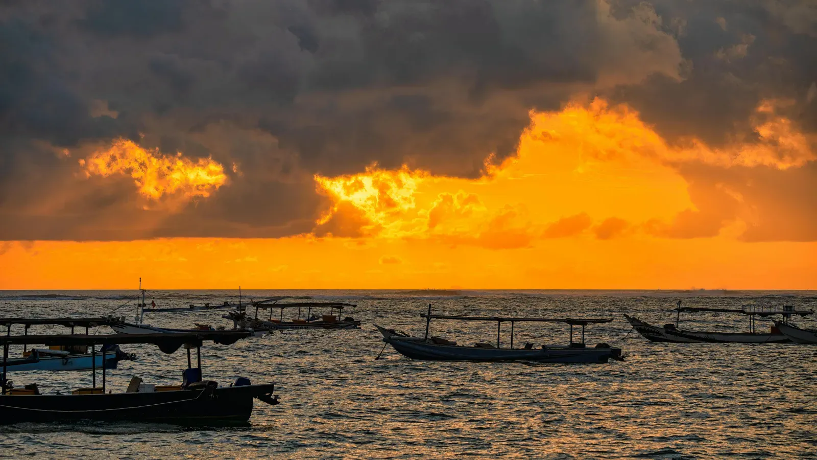 Fishing boat on open water with fishing equipment and coastline