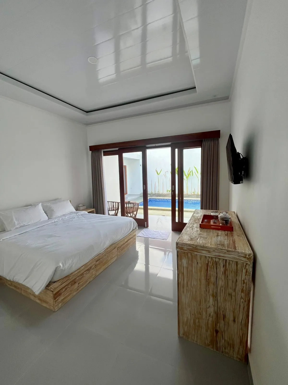 Made bed in a room at Iron Guest House