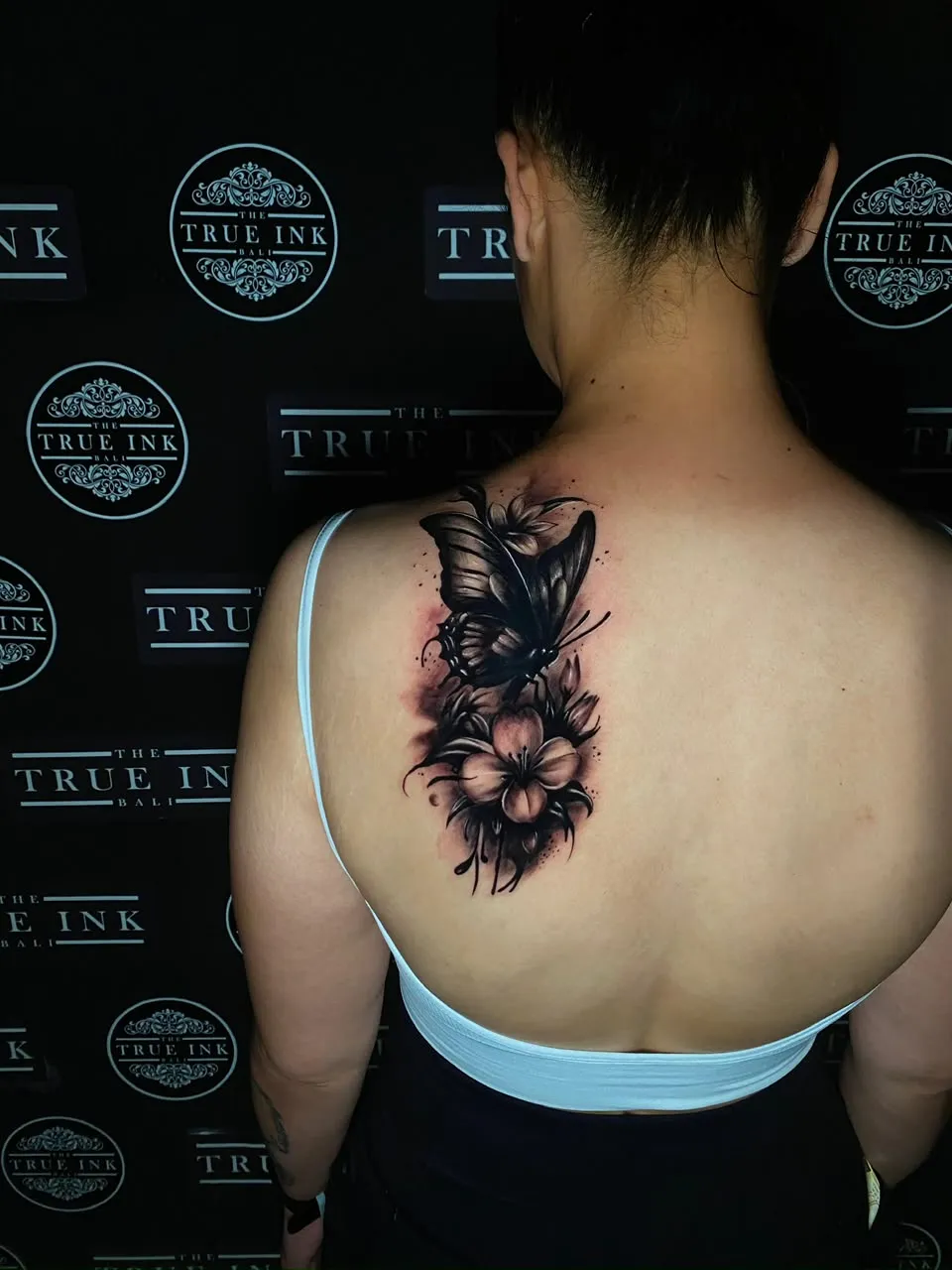 Butterfly and flowers on the upper back