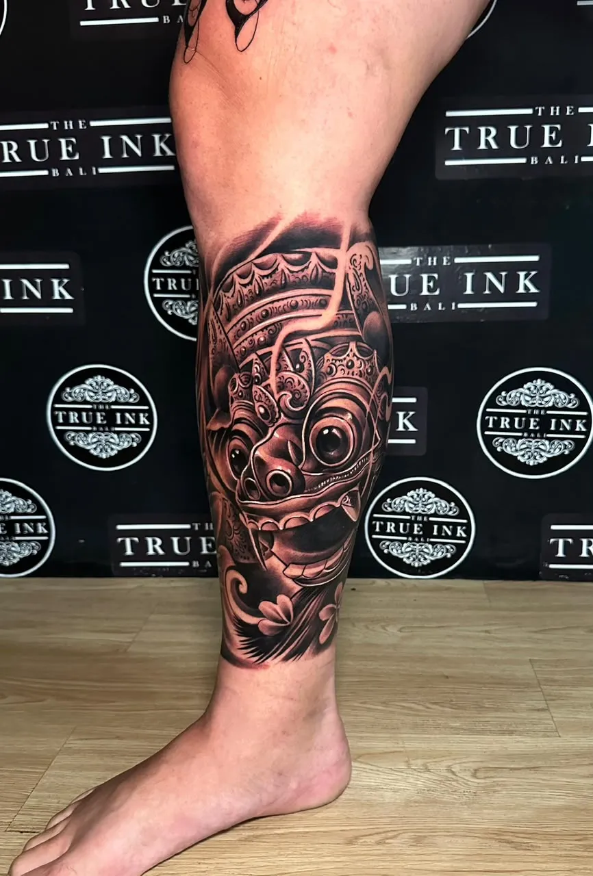 Balinese Barong mask tattoo on the calf at The True Ink Bali