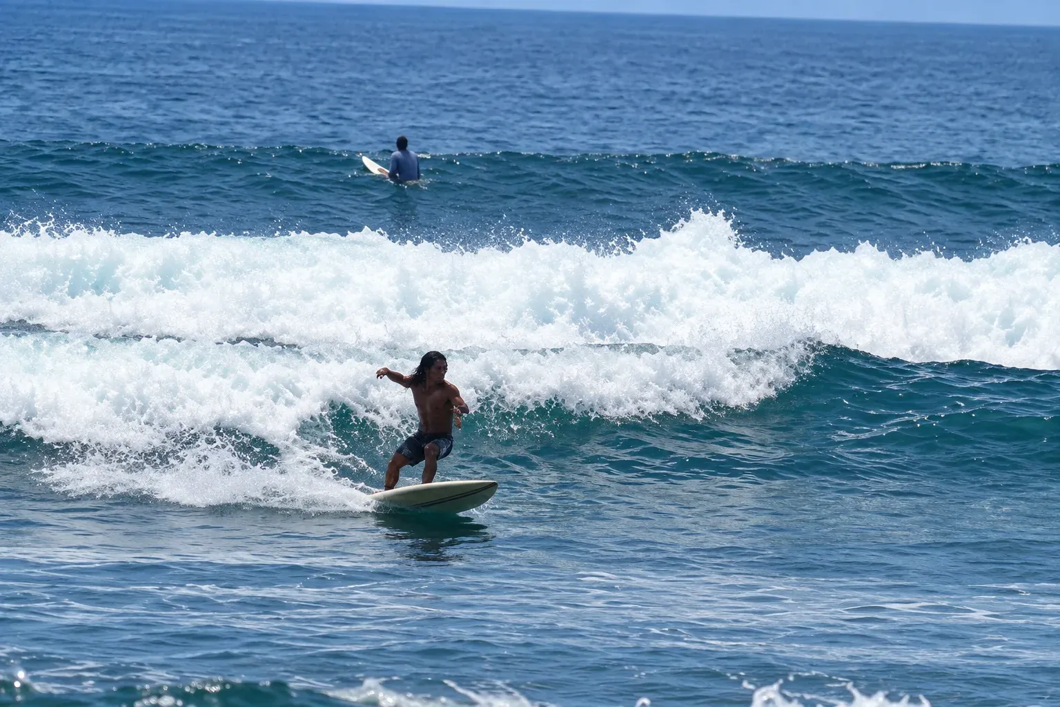 Beginner catching a small wave