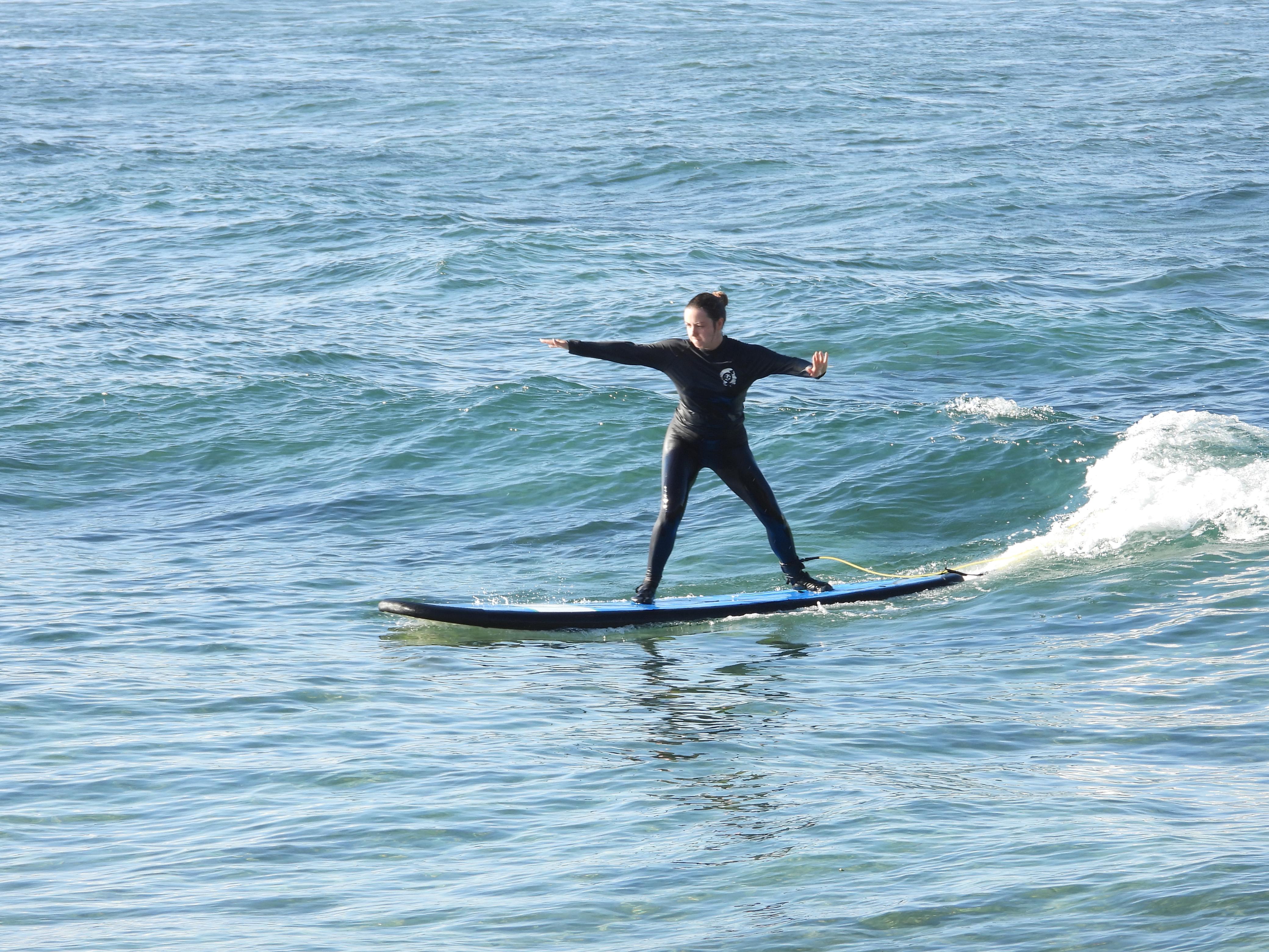Semi-private surf lesson in Bali with a coach helping two students on the board