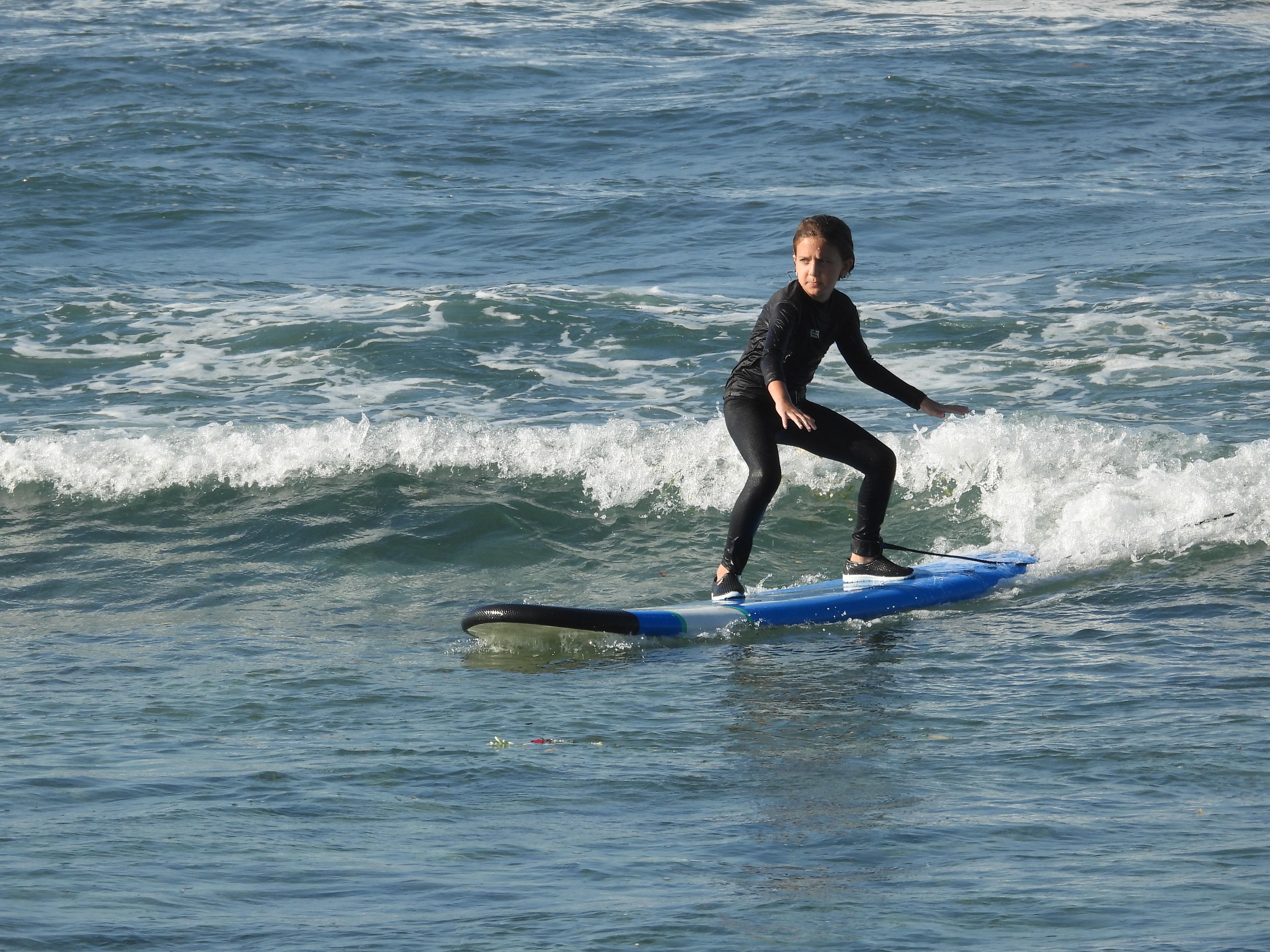 Golden Bali beach with surfboards and warm ocean light