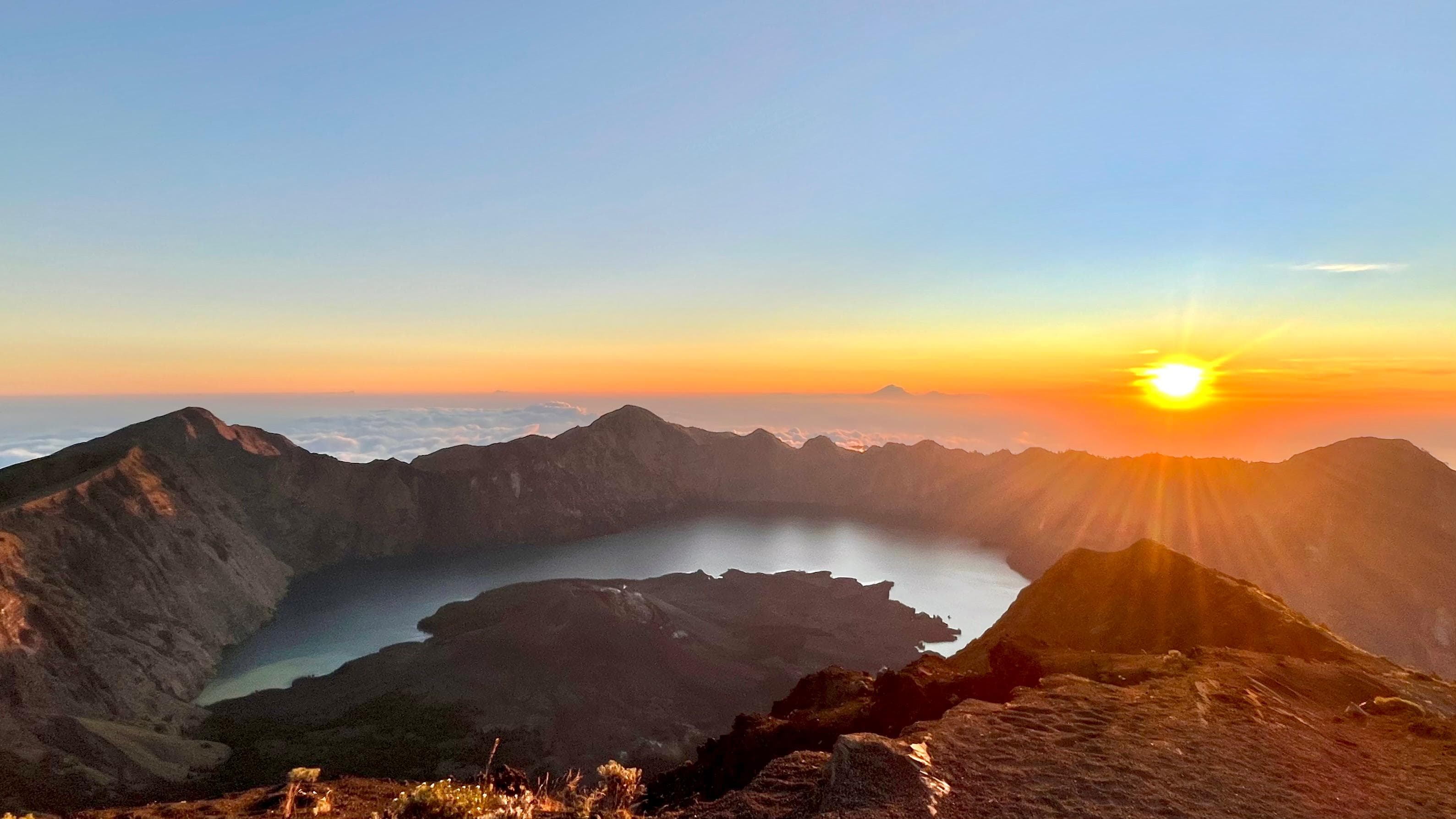 Hikers on Mount Rinjani trail with mountain vista