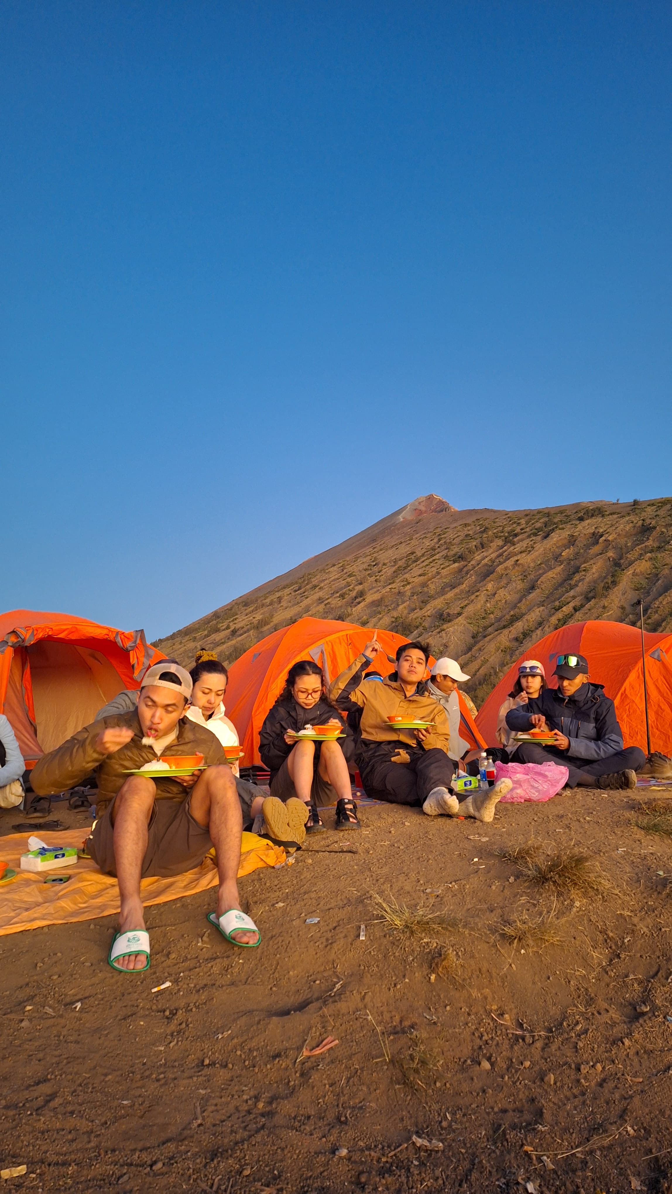 Guide assisting trekker on mountain trail