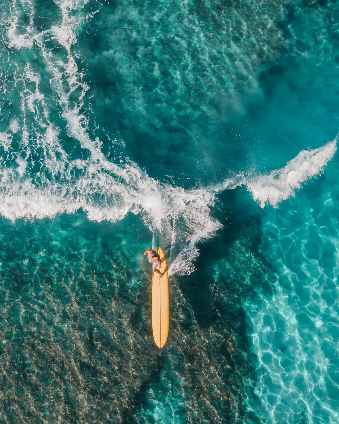 Surfer enjoying the ocean at golden hour in Lombok