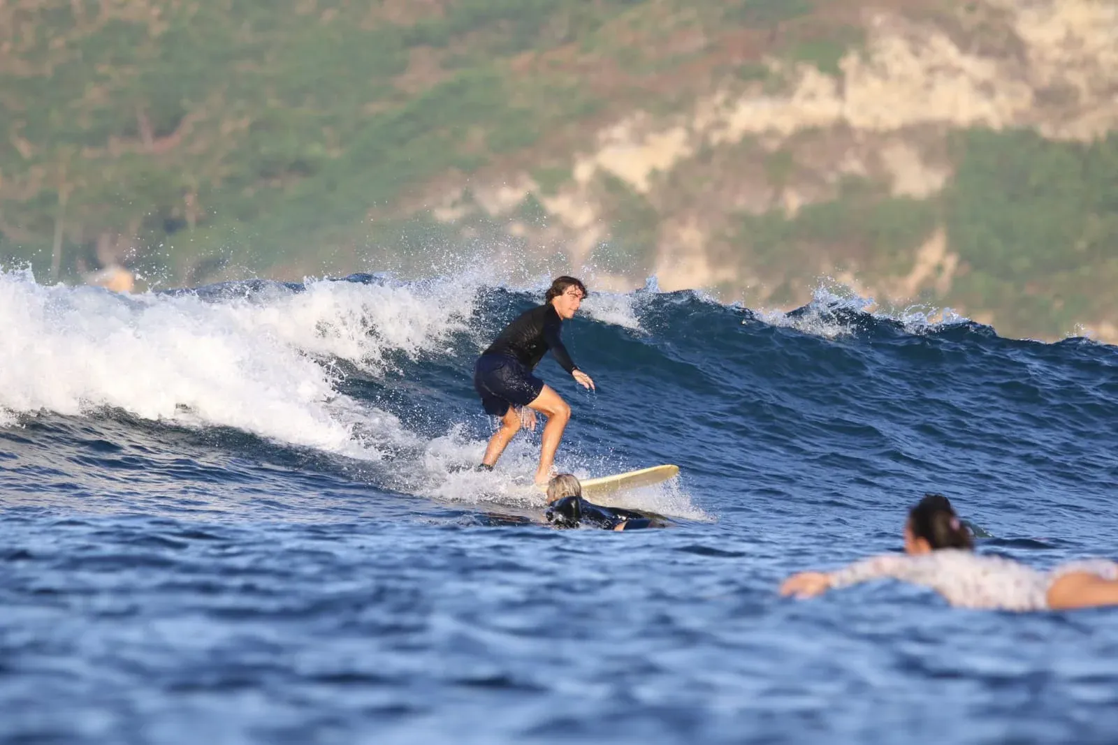 Two people surfing together