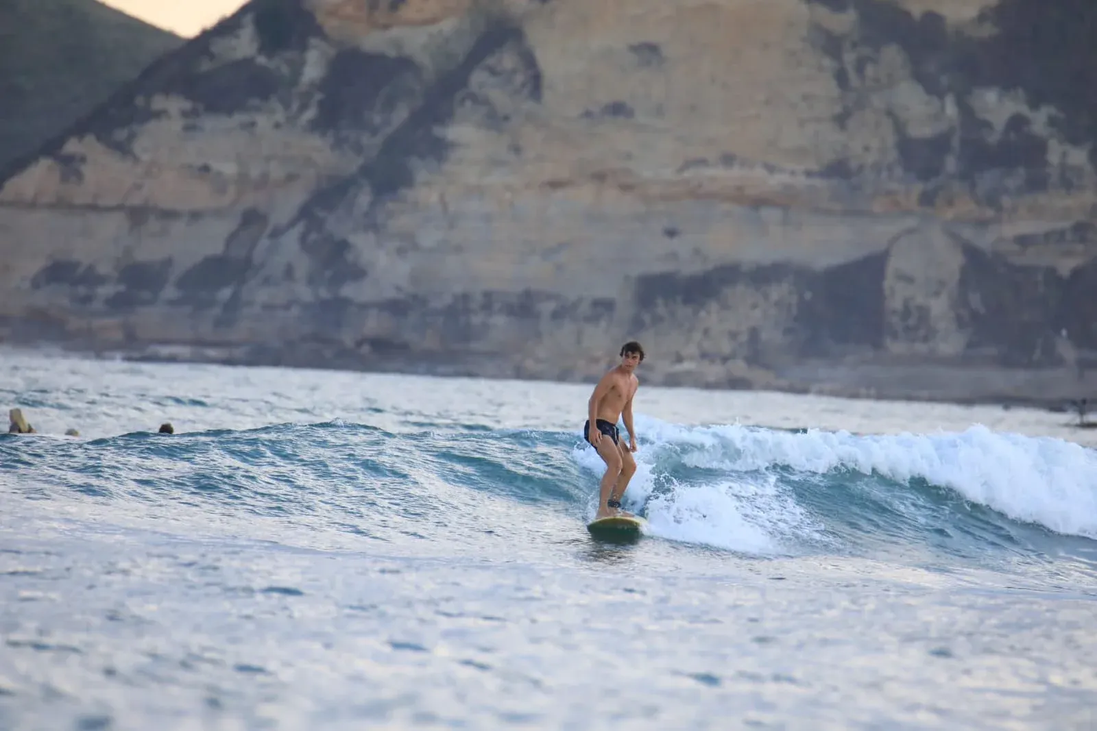 Surfer paddling on open water