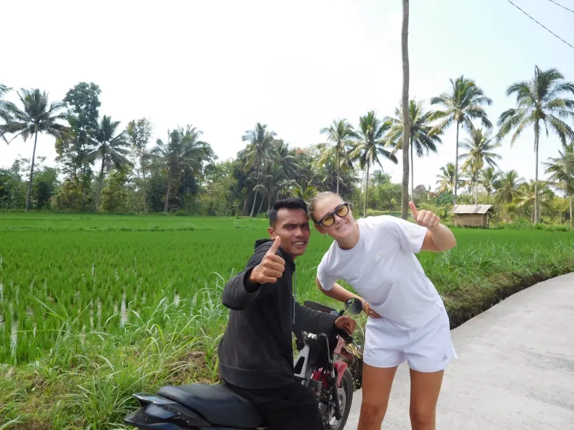 Guide and guest by the rice fields
