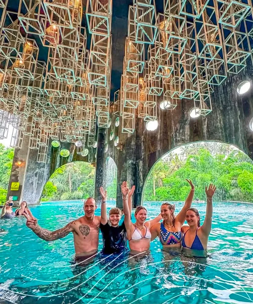 Guests in the indoor pool under hanging lanterns at Tlaga Singha