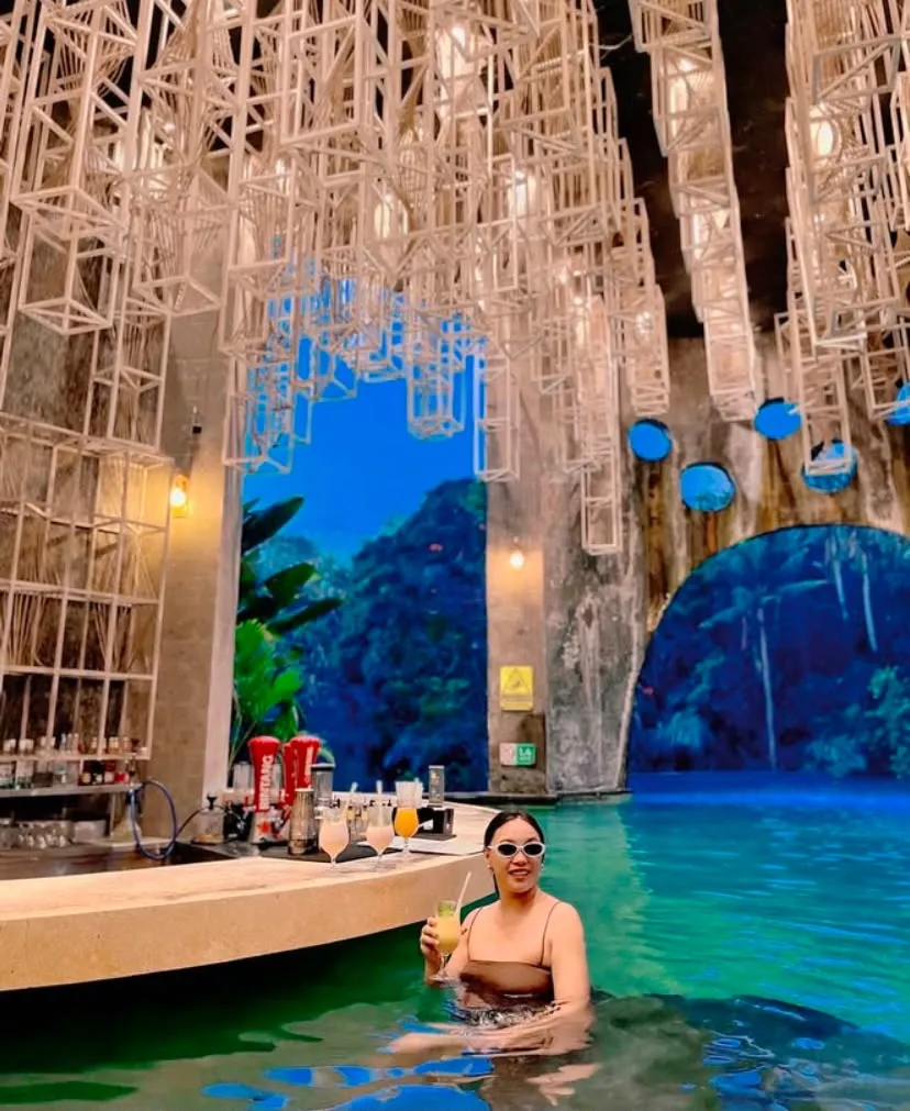 Guest in the stone-arch pool at Tlaga Singha