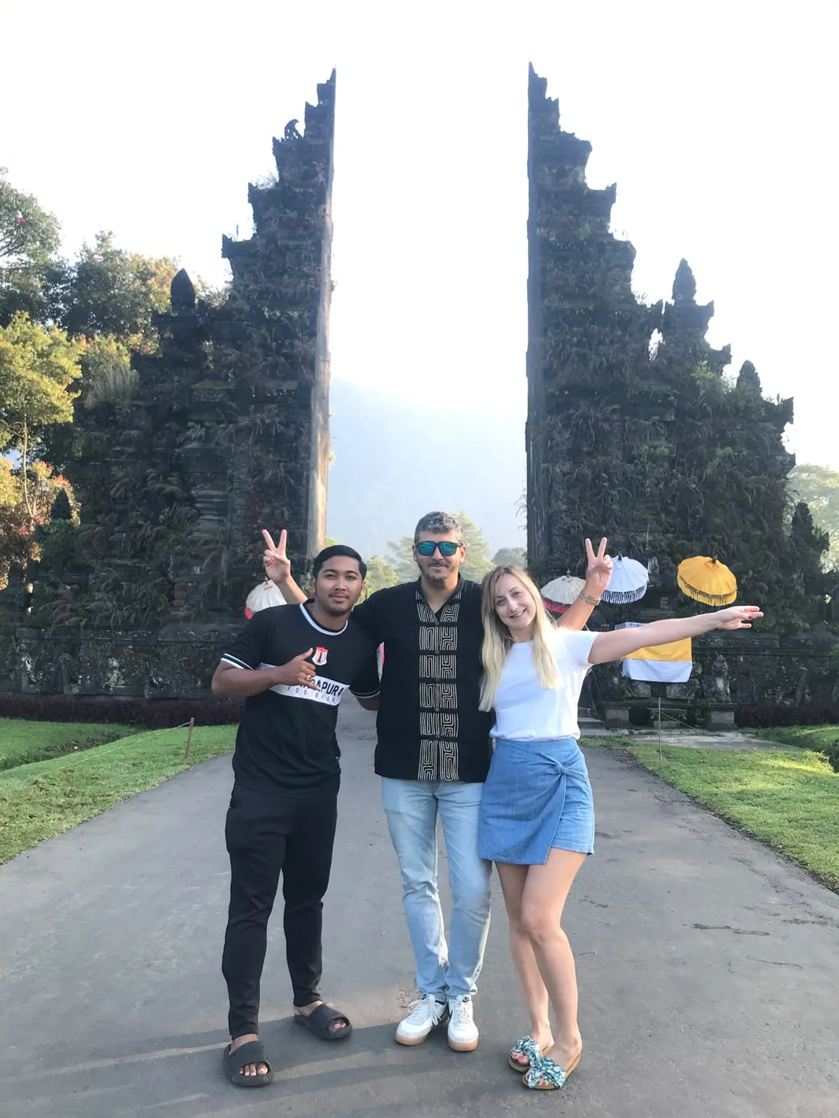 Guests and guide at a Balinese split temple gate