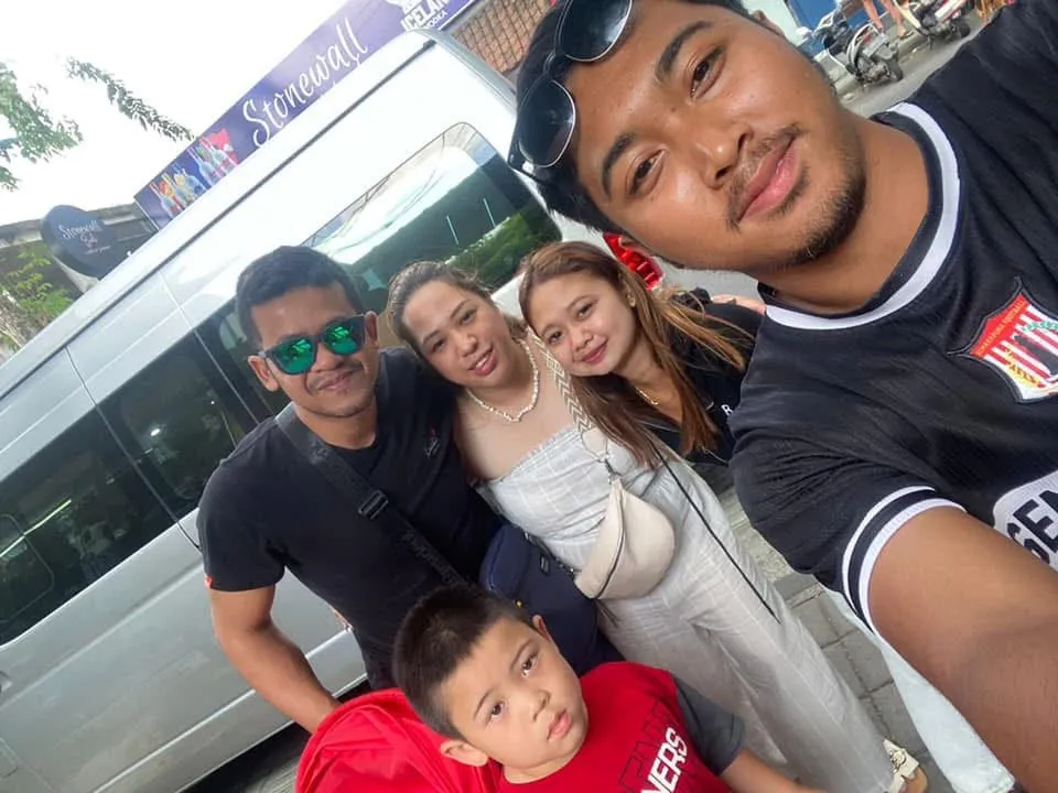 Family with their guide beside the tour van