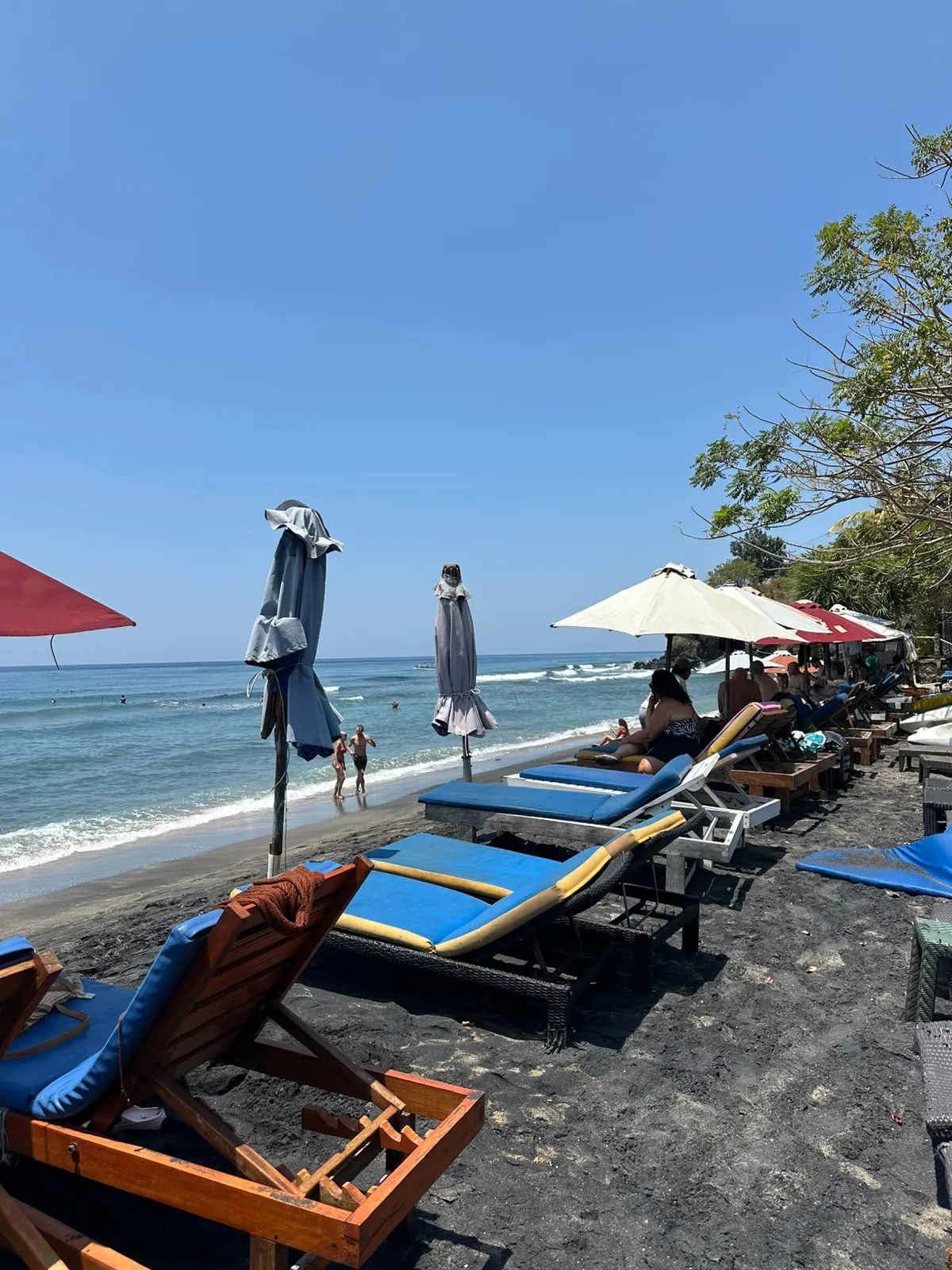 Sunbed on Lipah Beach with a young coconut