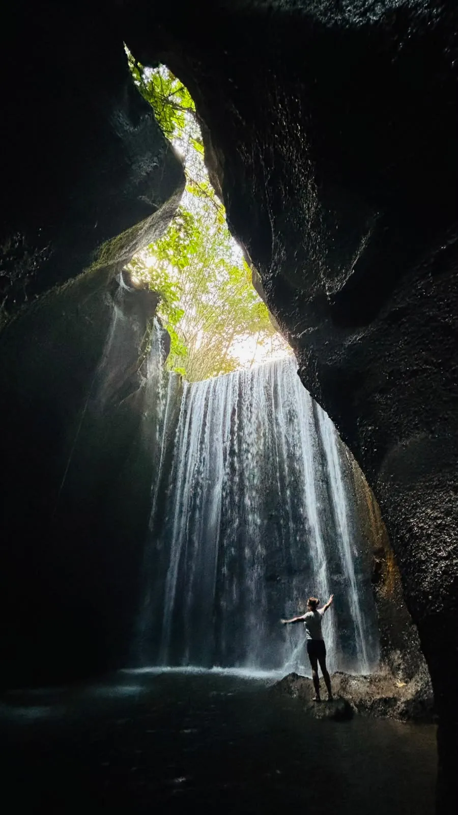 Standing at the base of an East Bali waterfall