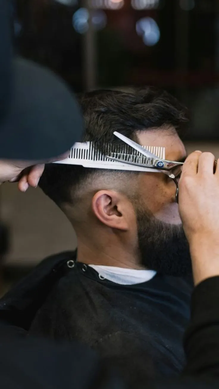 Barber clippers and tools during a precision cut