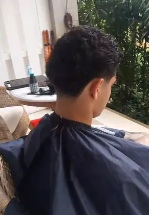 Barber finishing a cut