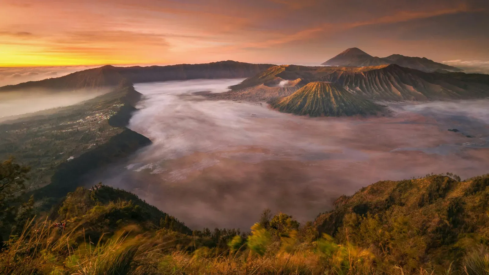 Sunrise light over a mountain lake and ridge
