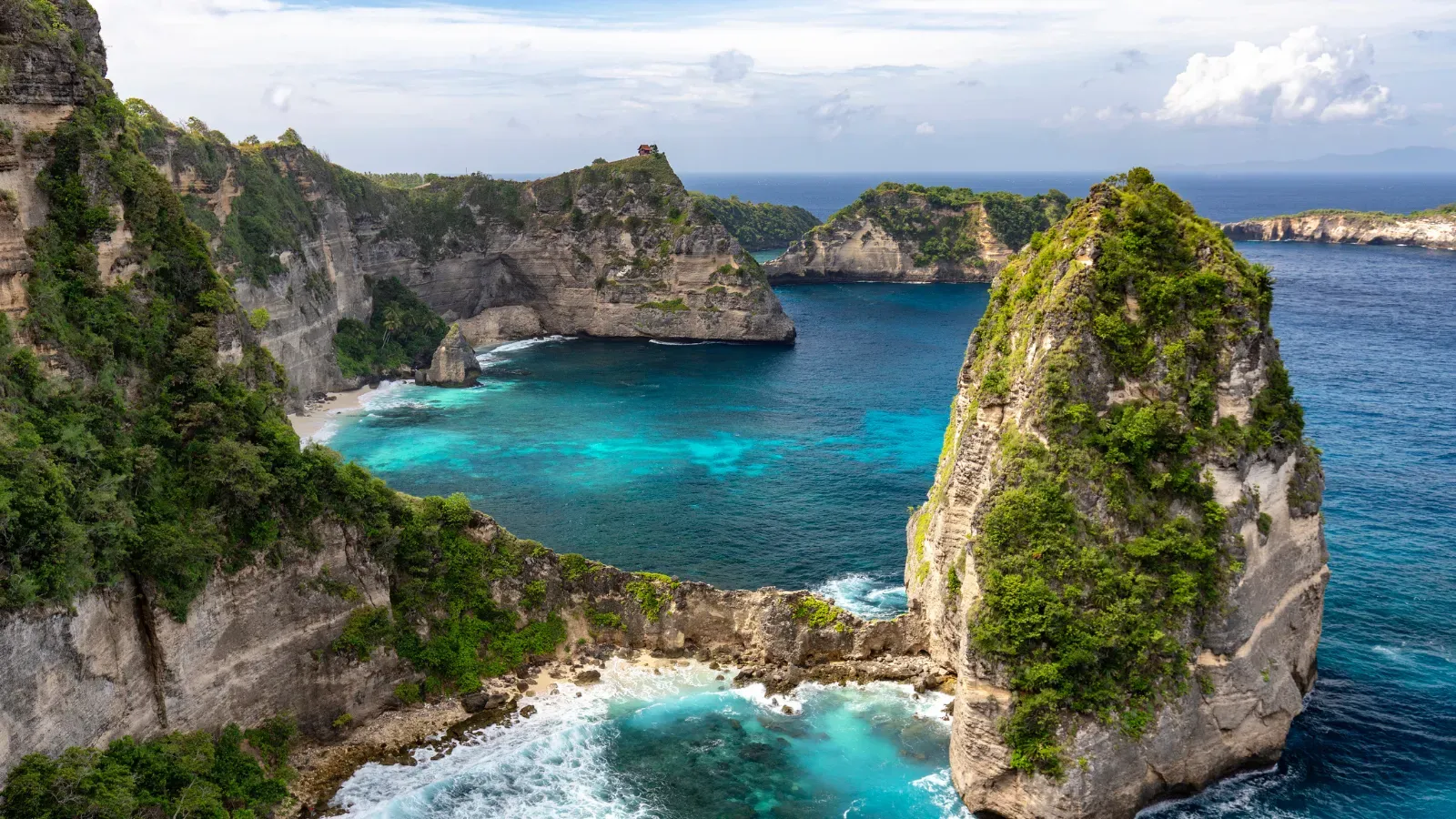 Sea temple on a rocky coastline at sunset, for the South Bali highlights tour.