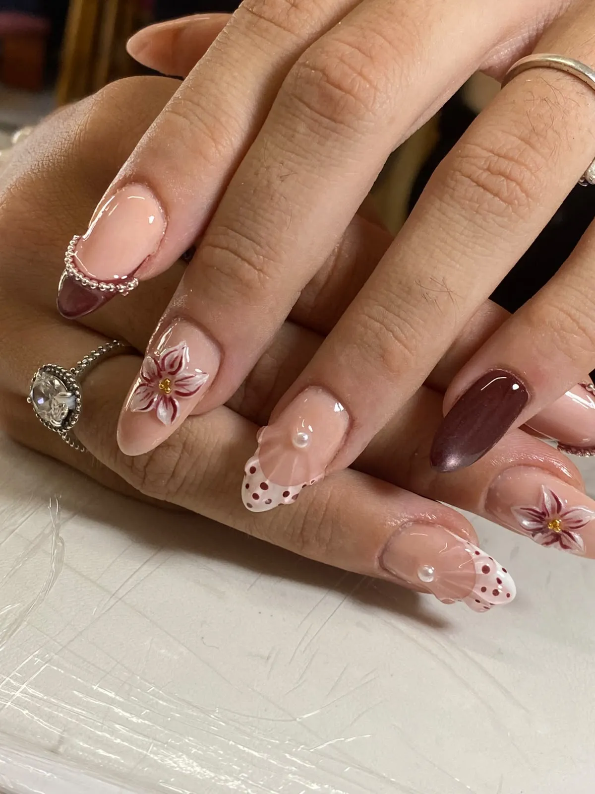 Soft pink manicure on a wooden table
