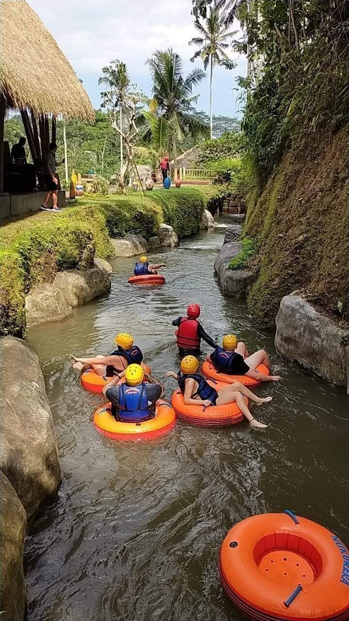 Guests enjoying a river tubing adventure in a tropical river