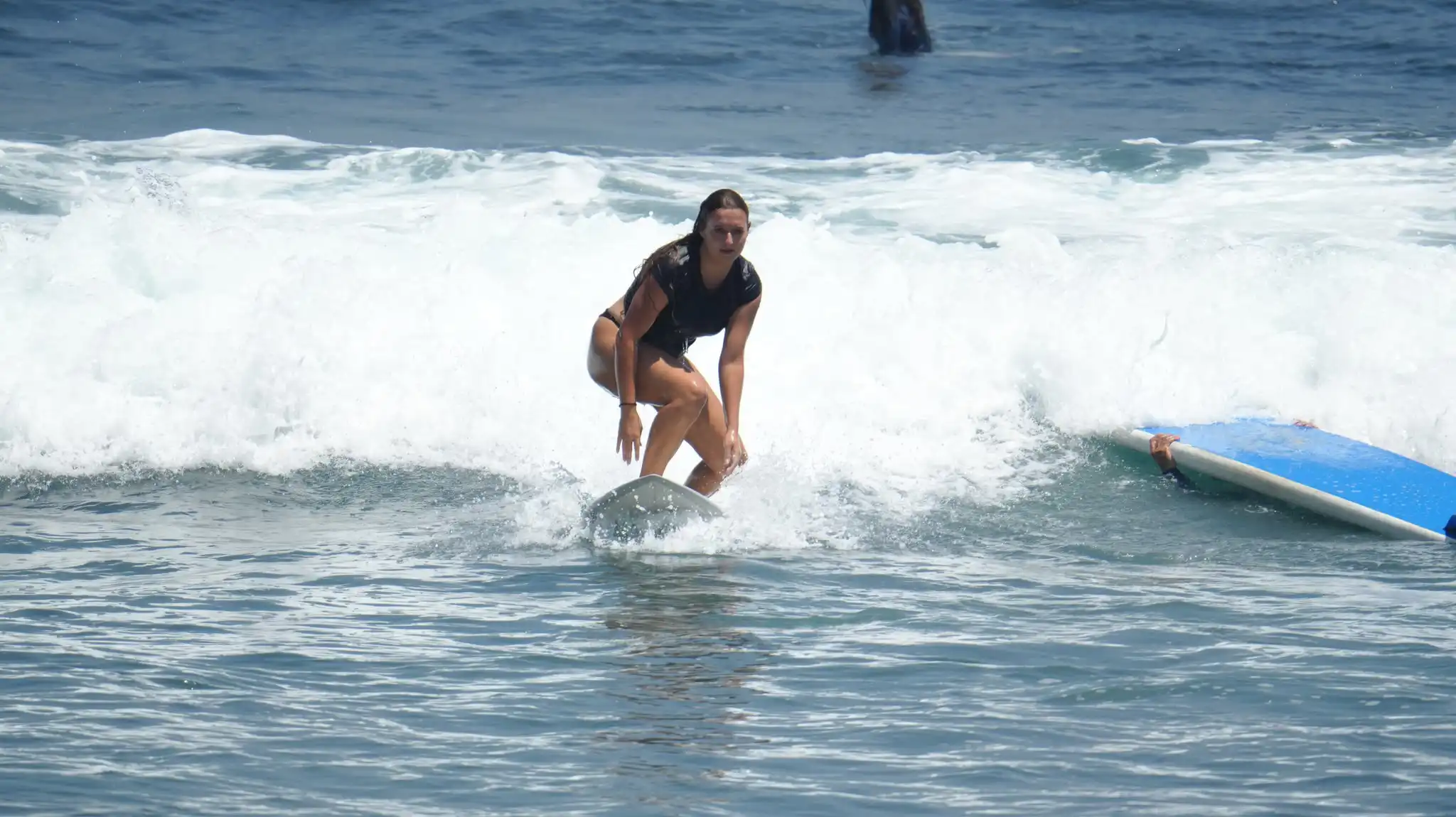 Surfer riding a white wave at Balangan Beach