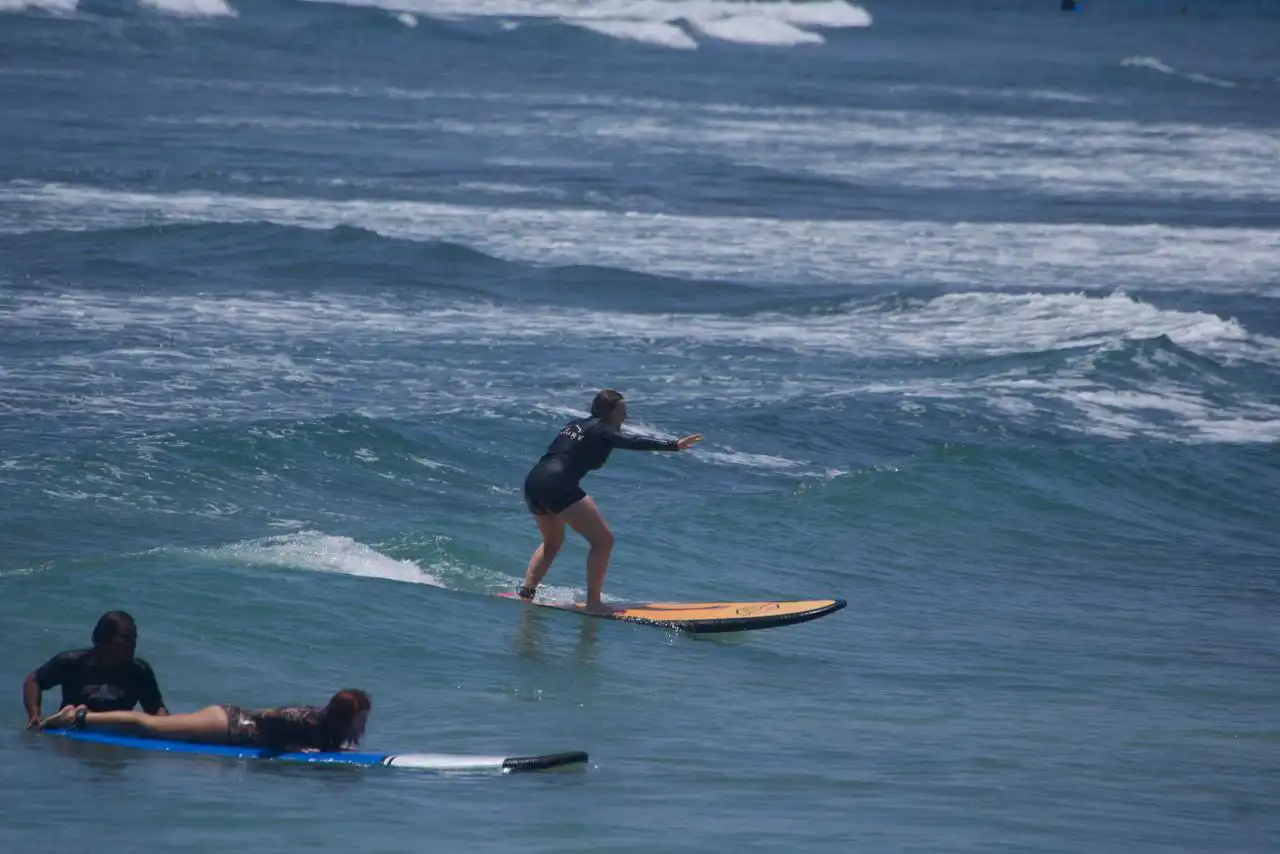 Surfer trimming along a green wave