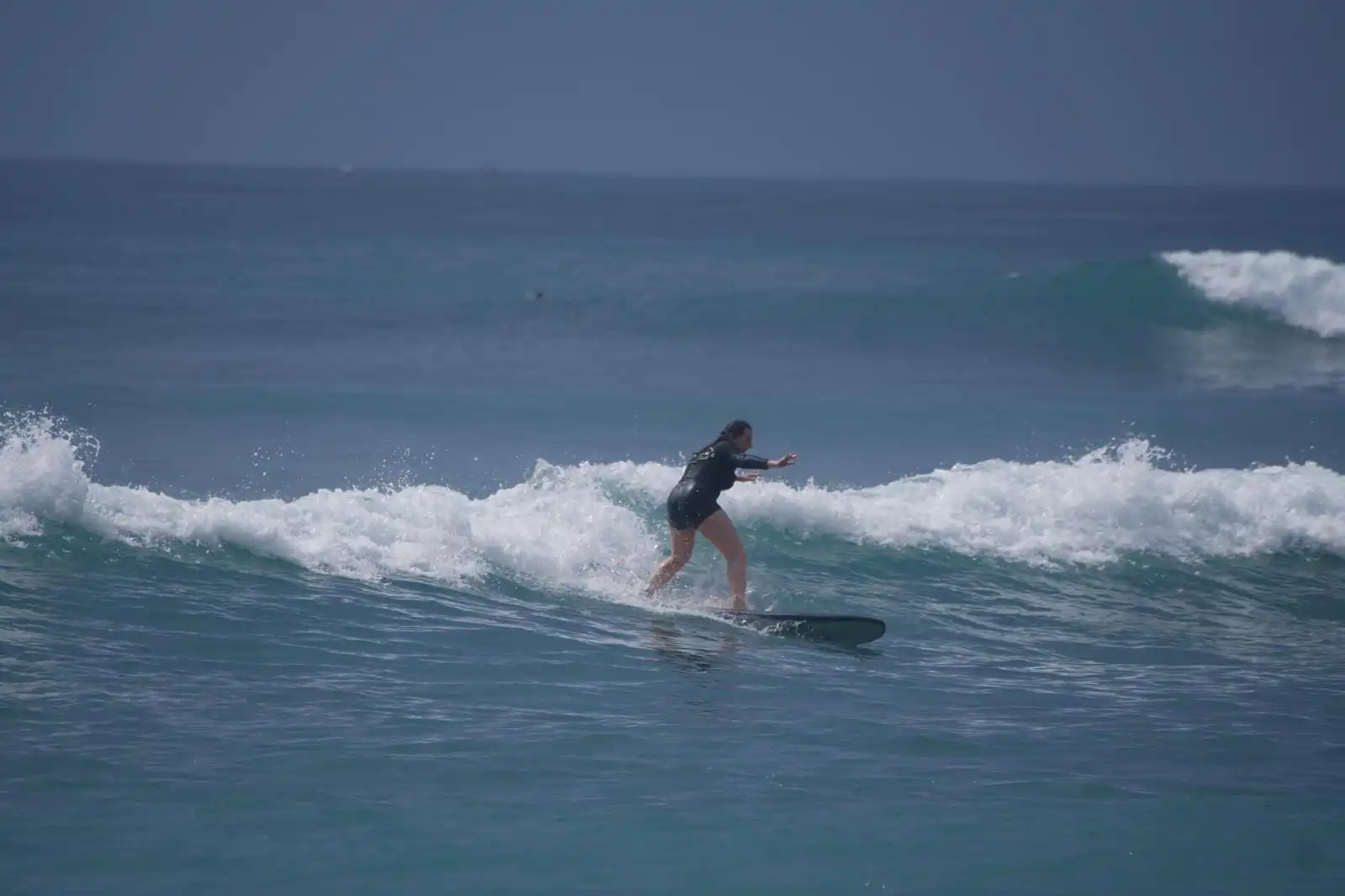Surfer riding the shoulder of a wave