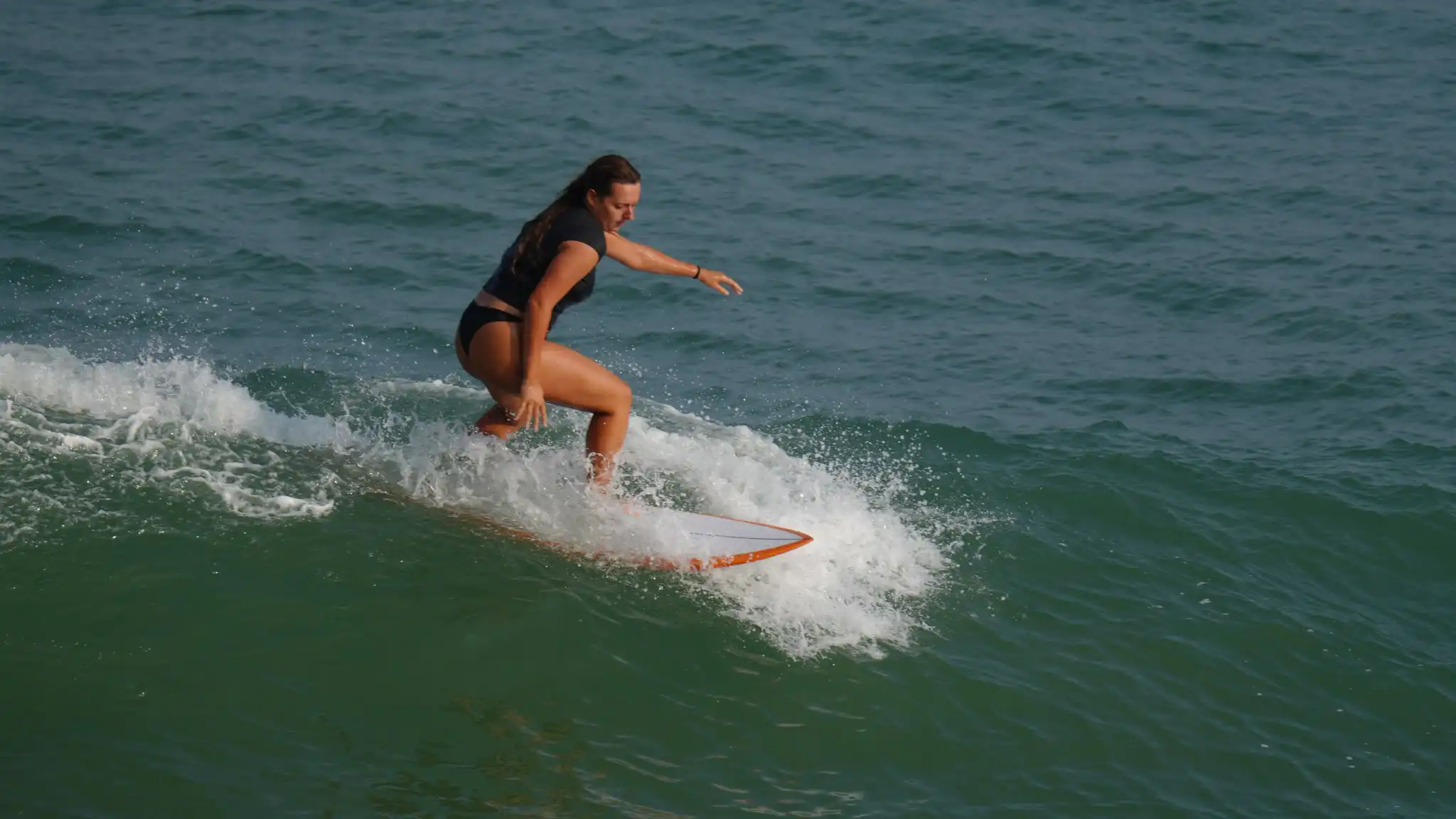 Surfer riding an open face at Balangan Beach
