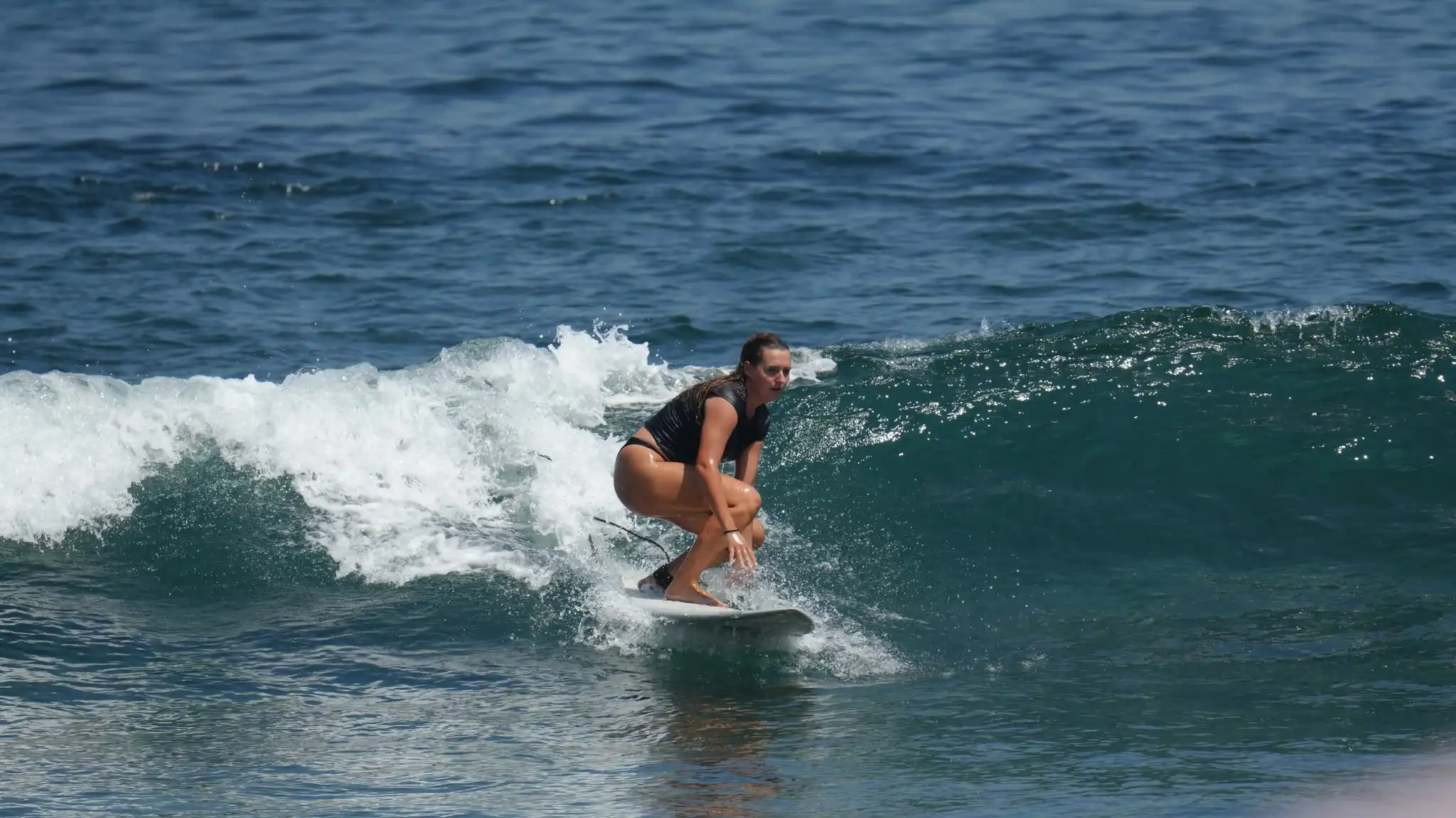 Surfer finishing a turn on a green wave