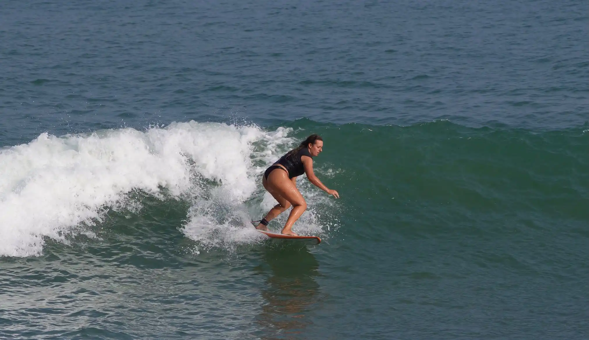Surfer riding the inside section of a wave