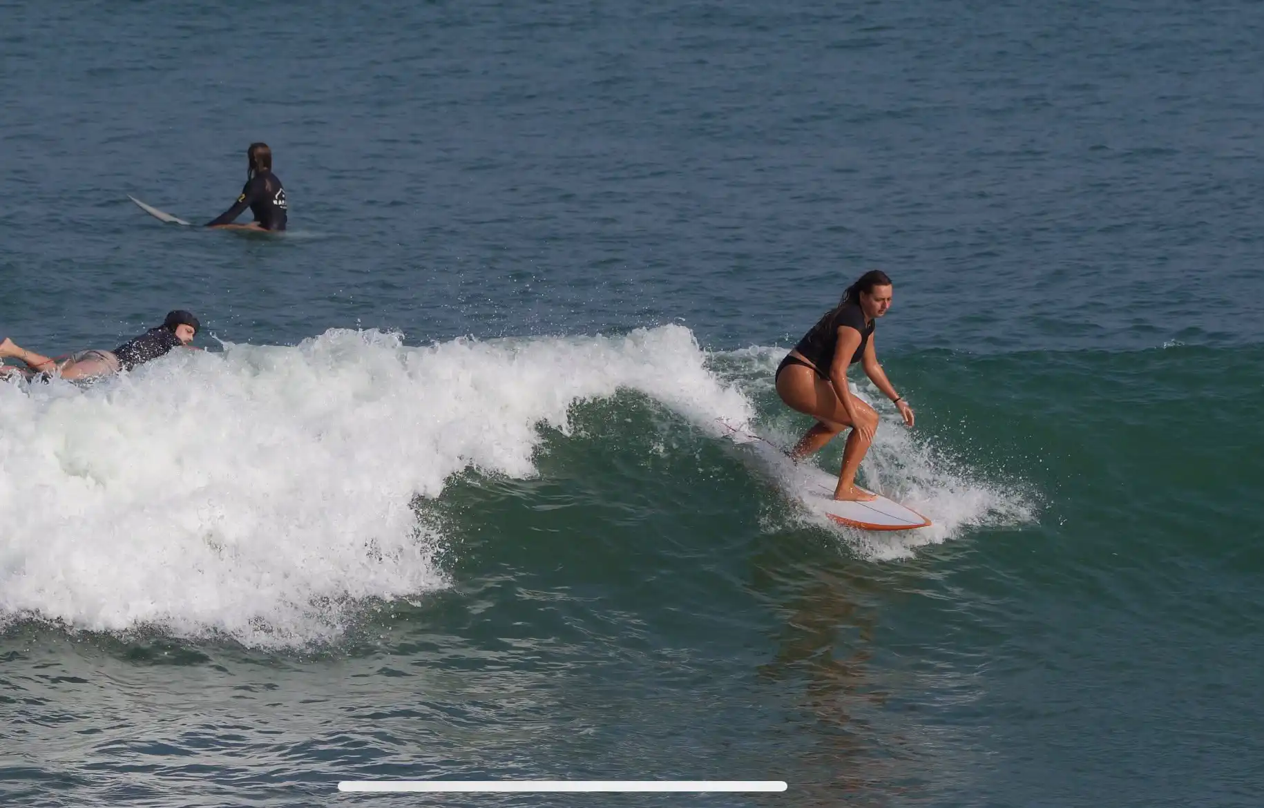 Surfer carving along the face of a wave at Balangan