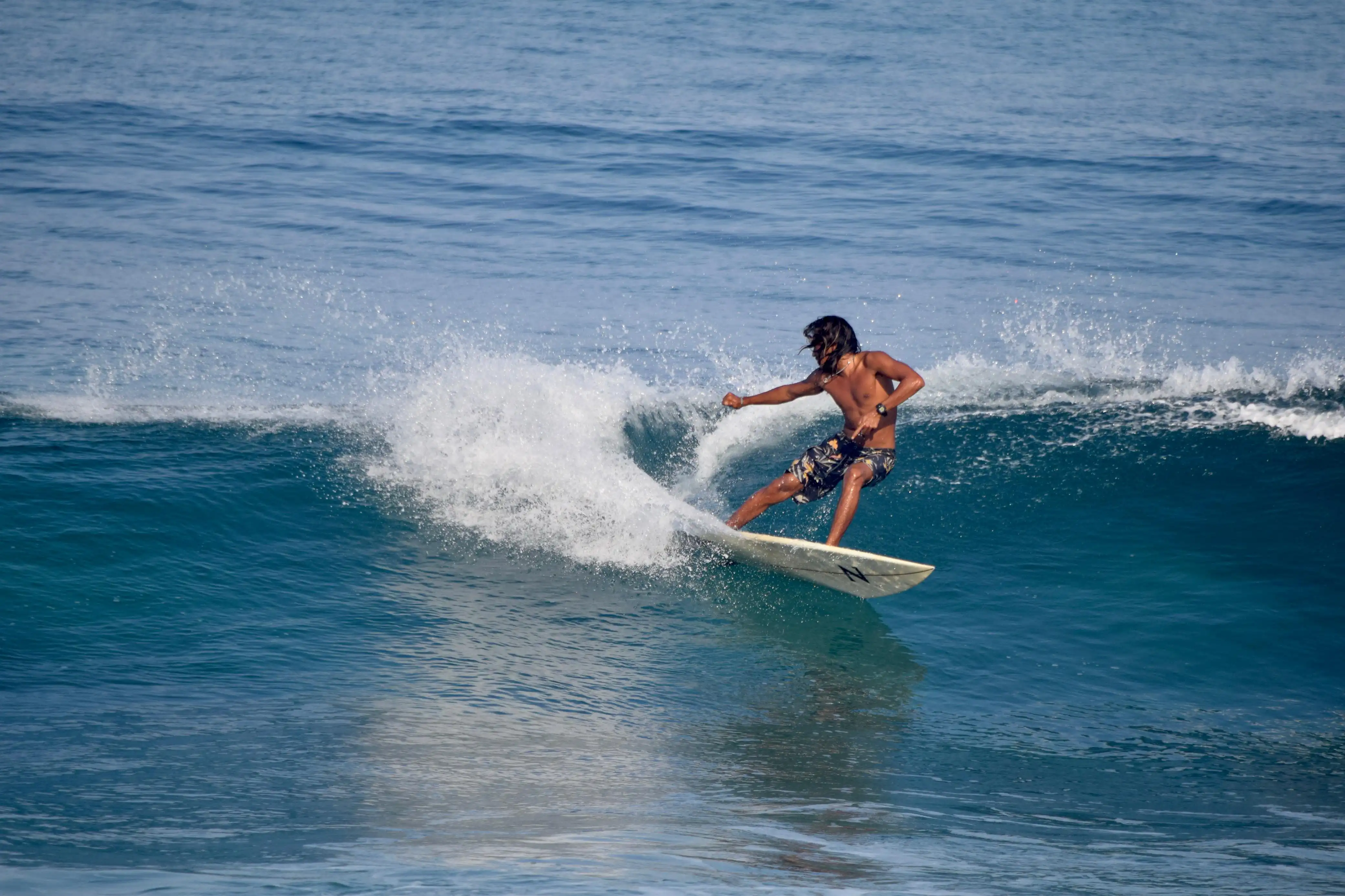 Surfer riding a wave during a surf session in Bali