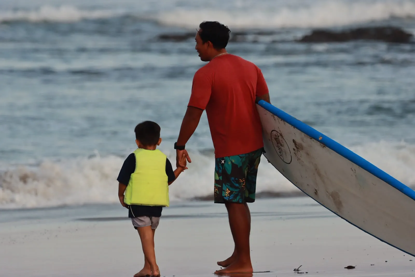 Surfer riding a wave on the Canggu coast with Young Surf Canggu